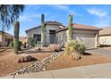 Beautifully landscaped front yard with desert plants and rock accents at 2272 W Jasper Butte Dr, Queen Creek, AZ 85144