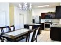 Charming kitchen featuring granite countertops, stainless appliances, island, chandelier, and breakfast area at 2745 W Jessica Ln, Phoenix, AZ 85041