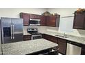 Modern kitchen with stainless steel appliances, granite countertops, and ample cabinet space at 2745 W Jessica Ln, Phoenix, AZ 85041