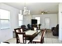 Open-concept living and dining area, chandelier, and comfortable leather furniture at 2745 W Jessica Ln, Phoenix, AZ 85041