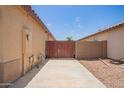 Spacious side yard featuring a private gate and low-maintenance desert landscaping at 3035 W Roberta Dr, Phoenix, AZ 85083