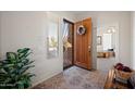 Inviting entryway with decorative door, floral wreath, neutral walls, and plenty of natural light at 3085 E Parkview Dr, Gilbert, AZ 85295