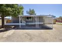 Single-story home with a covered parking area and a well-maintained exterior at 319 S 90 Pl, Mesa, AZ 85208