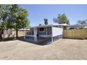 Well-maintained single-story home featuring a covered parking area and gravel landscaping at 319 S 90 Pl, Mesa, AZ 85208