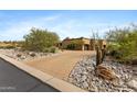 Paver driveway leading to a tan stucco home, surrounded by desert landscaping and native vegetation at 3553 N Crystal Peak Cir, Mesa, AZ 85207