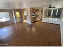Open living room featuring wood floors, lots of natural light, and a built-in cabinet at 4065 E University Dr # 4, Mesa, AZ 85205
