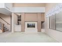 Open-concept living room featuring fireplace and access to the kitchen at 4201 W Renee Dr, Glendale, AZ 85308