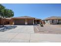 Charming single-story home featuring a three-car garage, tile roof, and low-maintenance desert landscaping at 45633 W Mountain View Rd, Maricopa, AZ 85139