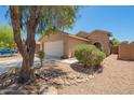 Charming single-story home with low maintenance desert landscaping and a two-car garage at 46123 W Sheridan Rd, Maricopa, AZ 85139