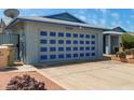 Home exterior featuring a large garage door with navy accents and a spacious driveway at 5215 W Onyx Ave, Glendale, AZ 85302
