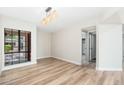 Bright dining area with wood floors and view of the outdoor patio and closet area at 5221 N 24Th St # 103, Phoenix, AZ 85016
