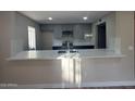 Updated kitchen features gray cabinets, stainless steel appliances, and a bright quartz countertop at 5221 N 24Th St # 103, Phoenix, AZ 85016
