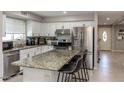 Modern kitchen with stainless steel appliances, granite island, and ample cabinet space at 546 S Ellsworth Rd, Mesa, AZ 85208