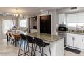 Bright kitchen with granite countertops, stainless steel appliances, and a convenient pantry at 546 S Ellsworth Rd, Mesa, AZ 85208