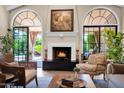 Close-up of fireplace and french doors leading to the garden with an outdoor patio at 7955 E Chaparral Rd # 73, Scottsdale, AZ 85250