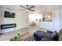 Open-concept living room with a fireplace and sleek, modern ceiling at 8055 E Thomas Rd # 104, Scottsdale, AZ 85251