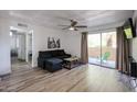 Comfortable living room with sliding glass doors and neutral decor at 8055 E Thomas Rd # 104, Scottsdale, AZ 85251