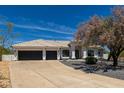 Charming home exterior with a tiled roof, two-car garage, desert landscaping, and a front driveway at 8156 E Questa Rd, Scottsdale, AZ 85255