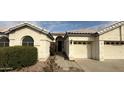Inviting front entrance with an arched doorway, a two-car garage, and manicured shrubbery at 854 W Mesquite St, Gilbert, AZ 85233