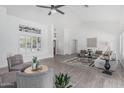 Bright living room featuring neutral paint, tile floors, vaulted ceilings, and comfortable seating arrangements at 921 N Oxford Ln, Chandler, AZ 85225