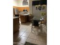 Well-lit kitchen and dining area, featuring an island, stainless steel appliances, and a modern chandelier at 9733 W Mcrae Way, Peoria, AZ 85382