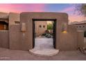 Beautiful front gate offering an inviting entrance to a courtyard with lush desert landscaping at 9913 E Quarry Trl, Scottsdale, AZ 85262