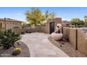 Picturesque courtyard with custom fountain and flagstone pathway leading to the home's entrance at 9913 E Quarry Trl, Scottsdale, AZ 85262