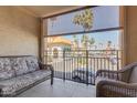 Balcony with outdoor seating that overlooks the parking area and landscaping at 10330 W Thunderbird Blvd # A209, Sun City, AZ 85351