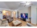 Living room with wood floors and ceiling fan, offering comfortable seating and entertainment at 10330 W Thunderbird Blvd # A209, Sun City, AZ 85351