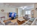 Cozy living room features a ceiling fan and ample natural light from a window at 10330 W Thunderbird Blvd # A209, Sun City, AZ 85351
