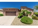 Charming single-story home with a two-car garage, desert landscaping, and a well-maintained yard at 13052 W Mine Trl, Peoria, AZ 85383