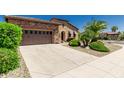 Well maintained front yard with a two car garage and desert landscaping in a desert climate at 13052 W Mine Trl, Peoria, AZ 85383