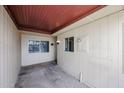 A covered patio with a secure gate and a light fixture, perfect for relaxing outdoors at 13618 N 98Th Ave # C, Sun City, AZ 85351