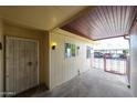 A covered patio with a secure gate and a light fixture, perfect for relaxing outdoors at 13618 N 98Th Ave # C, Sun City, AZ 85351