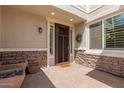 Inviting front entry with decorative stone accents, a charming wreath, and a welcoming doormat at 14674 W Pasadena Ave, Litchfield Park, AZ 85340