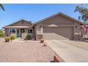 Charming single-story home featuring a well-maintained yard with desert landscaping and a two-car garage at 1703 Leisure World --, Mesa, AZ 85206