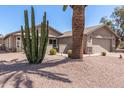 Charming single-story home featuring a well-maintained yard with desert landscaping and a two-car garage at 1703 Leisure World --, Mesa, AZ 85206