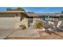 Charming home featuring a gated front porch with well-maintained landscaping and mature plants at 17668 N Del Webb Blvd, Sun City, AZ 85373
