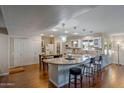 Bright open kitchen with granite counters, stainless appliances, a large island, and modern lighting at 17668 N Del Webb Blvd, Sun City, AZ 85373