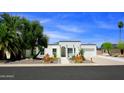 Inviting exterior showcasing the home's crisp white facade, arched entryway, and desert landscaping under a bright sky at 1806 W Rosewood Ct, Chandler, AZ 85224