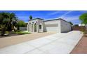 Expansive driveway and garage showcasing the white home's architecture and functional space at 1806 W Rosewood Ct, Chandler, AZ 85224
