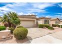 Charming single-story home features low-maintenance landscaping, tile roof, and two car garage at 18131 W Addie Ln, Surprise, AZ 85374