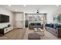 Bright living room boasts modern decor, wood floors, and plenty of natural light at 1823 E Chelsea Ln # 106, Gilbert, AZ 85295