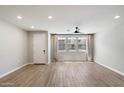 Bright, open living area with hardwood floors, a ceiling fan, and large windows at 1823 E Chelsea Ln # 106, Gilbert, AZ 85295