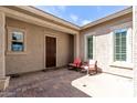 Welcoming courtyard with two rocking chairs and a charming entryway at 18929 W Windsor Blvd, Litchfield Park, AZ 85340