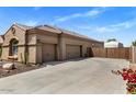 Spacious three-car garage providing ample parking and storage, with low water landscaping at 21200 E Camacho Rd, Queen Creek, AZ 85142