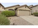 Charming home featuring a spacious two-car garage, desert landscape, and well-maintained front yard at 2152 E Casitas Del Rio Dr, Phoenix, AZ 85024