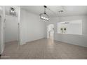 Spacious living room features tile floors, recessed lighting, arched doorway, and neutral wall colors at 2152 E Casitas Del Rio Dr, Phoenix, AZ 85024