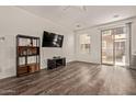 Spacious living room featuring wood floors, neutral walls, and access to a balcony at 22125 N 29Th Ave # 137, Phoenix, AZ 85027