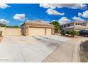 Spacious three-car garage with stone accents and a wide driveway, perfect for extra parking at 22351 N 67Th Dr, Glendale, AZ 85310